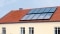 The picture shows solar panels on the roof as heating backup.